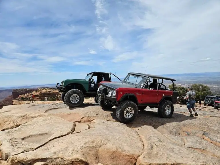 Green and red early Broncos on a slickrock ledge
