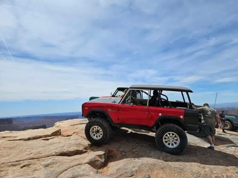 Red early Bronco on slickrock with open sky behind it